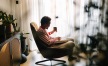 a man sitting in a chair reading a book